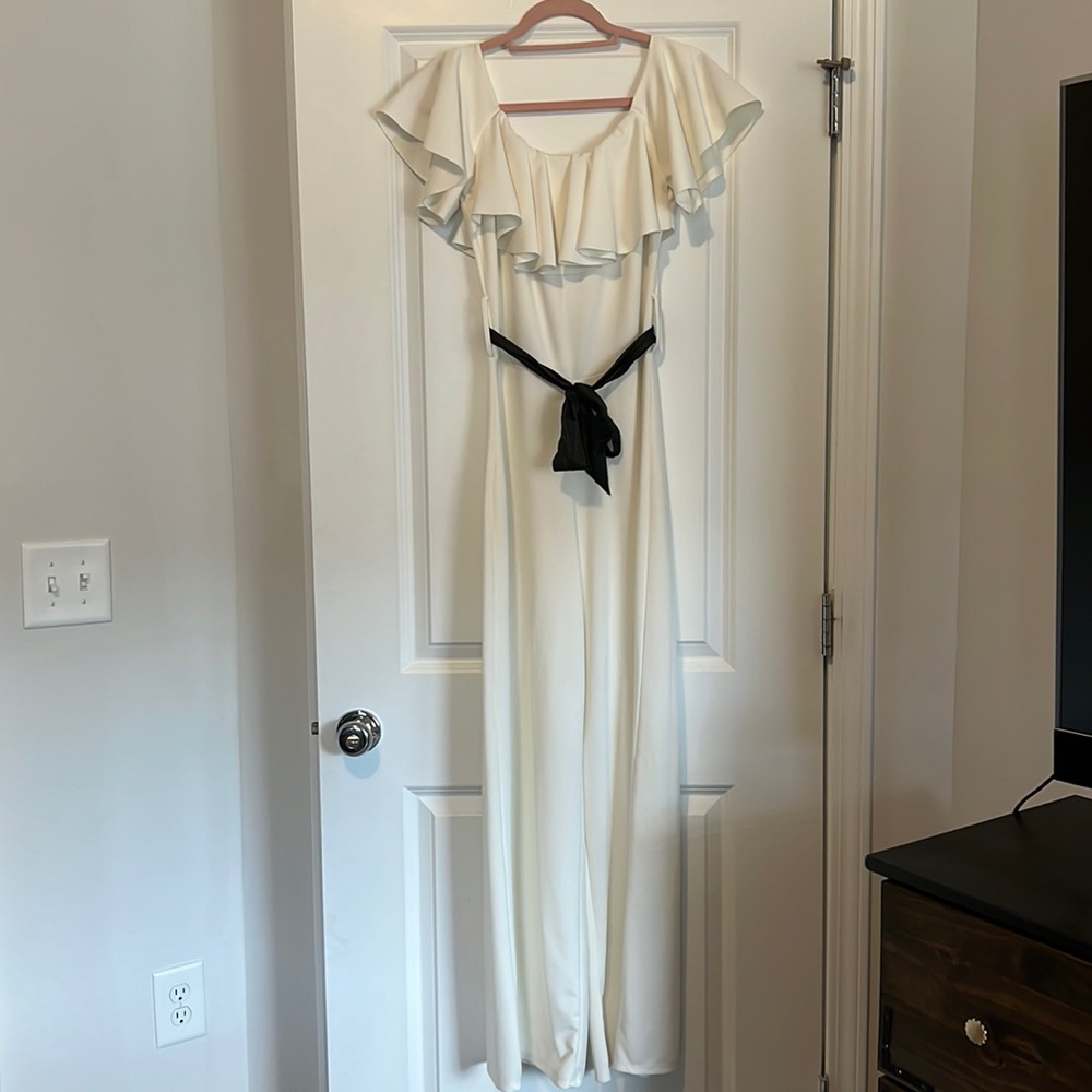 European, white, stretchy jumpsuit with black belt. Size: S